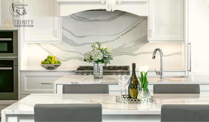 Cambria Brittanica Kitchen Countertops Bathroom Countertops White and Gray Quartz Countertops White Cabinets Kitchen Island marble looking quartz International Granite and Stone Trinity Construction and Design Collaboration gray furniture gray flooring white tile white backsplash