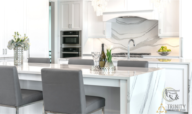 Cambria Brittanica Kitchen Countertops Bathroom Countertops White and Gray Quartz Countertops White Cabinets Kitchen Island marble looking quartz International Granite and Stone Trinity Construction and Design Collaboration gray furniture gray flooring white tile white backsplash