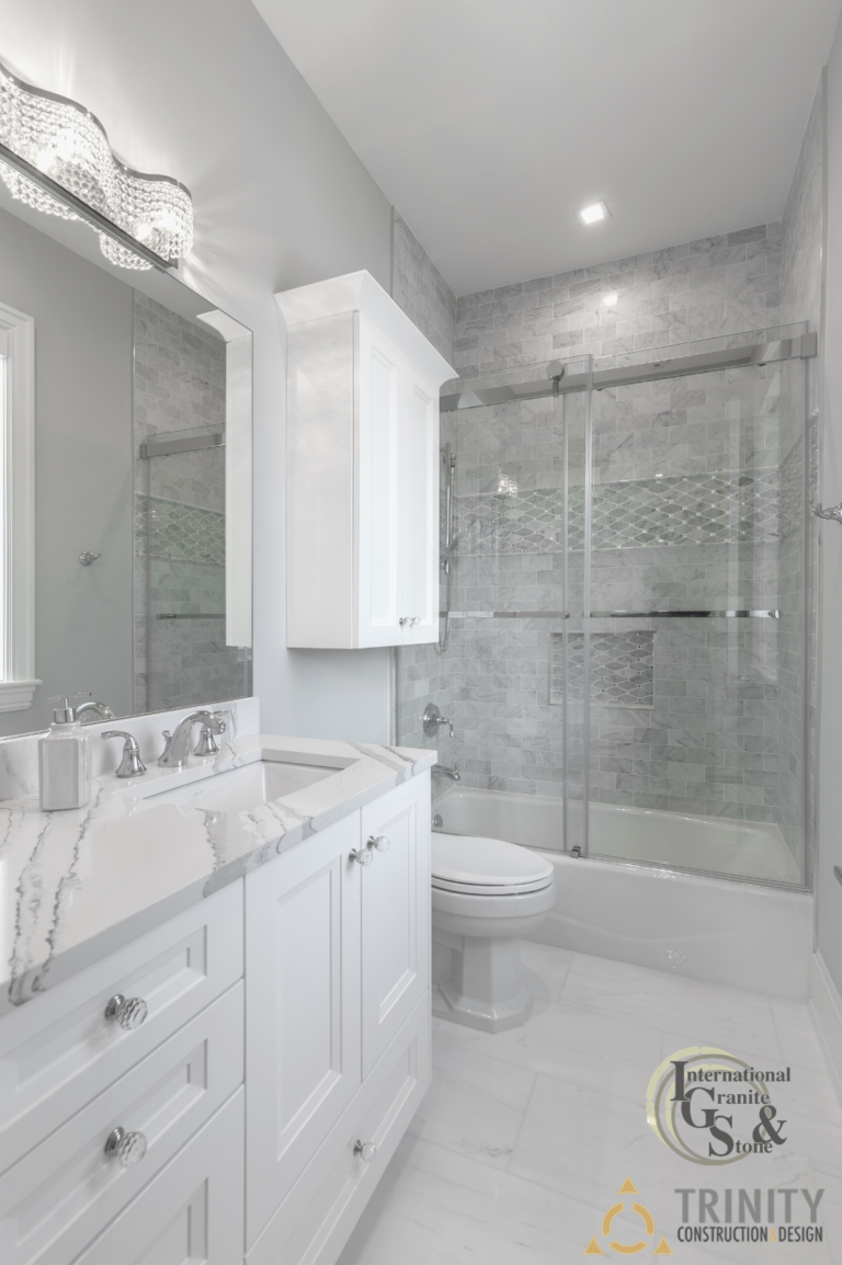Cambria Brittanica Kitchen Countertops Bathroom Countertops White and Gray Quartz Countertops White Cabinets Kitchen Island marble looking quartz International Granite and Stone Trinity Construction and Design Collaboration gray furniture gray flooring white tile white backsplash