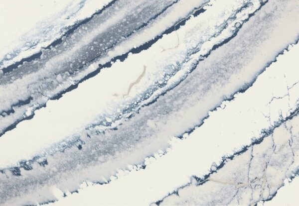 Close-up view of Cambria Inverness Bristol Bay Quartz countertop featuring stormy-blue waves, cool white backdrop, and debossed Inverness veins, showcasing its high gloss finish and durability for residential and commercial applications.