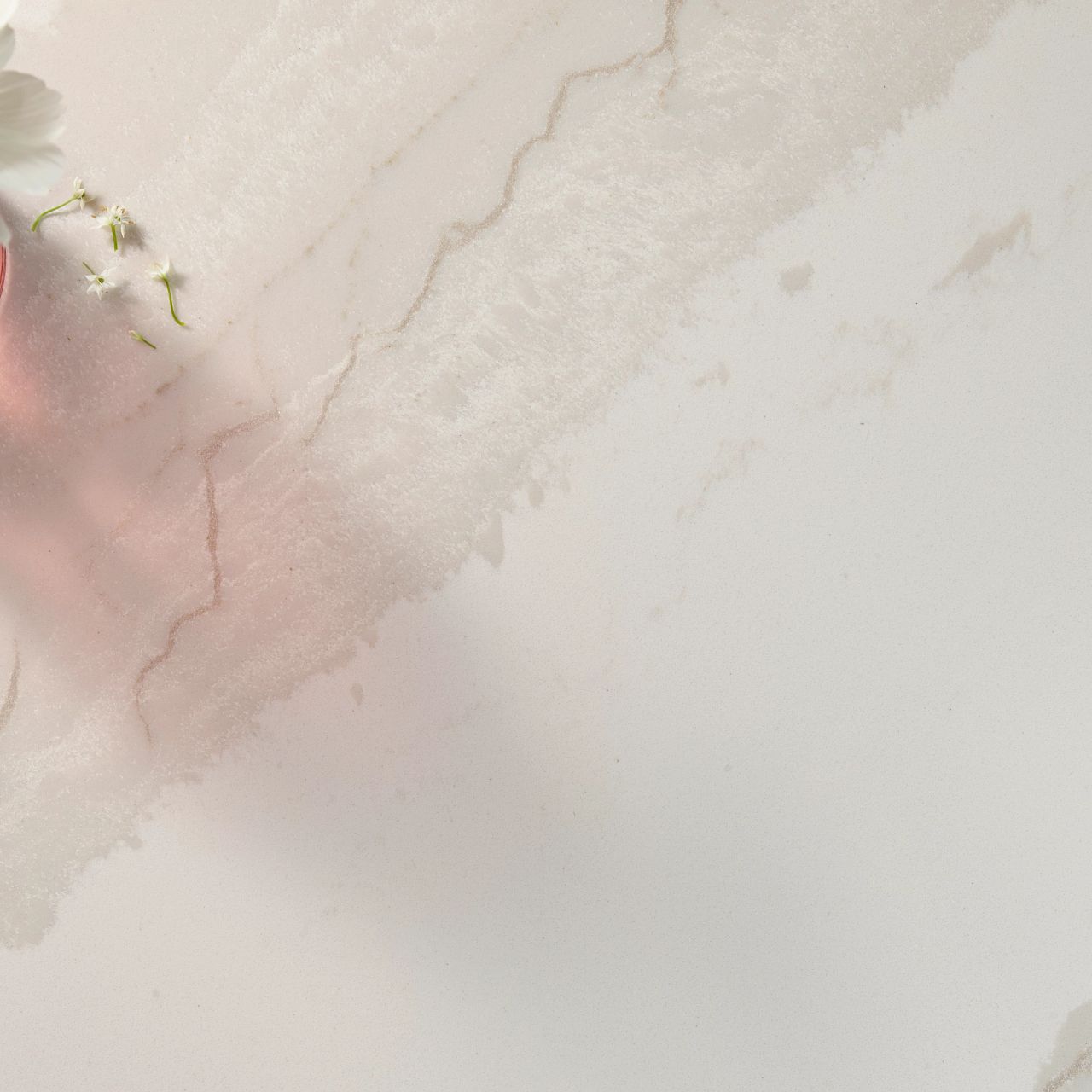 A close-up view of Cambria Inverness Swansea Quartz, showcasing its tonal white, marbled design with intricate debossed Inverness veins. Available in both high gloss and Cambria Matte finishes