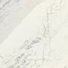 Close-up view of Cambria Windsor Steel Satin Ridge Quartz, showcasing its steel-toned wave patterns, warm honey-colored sand backdrop, and contrasting cool charcoal elements.