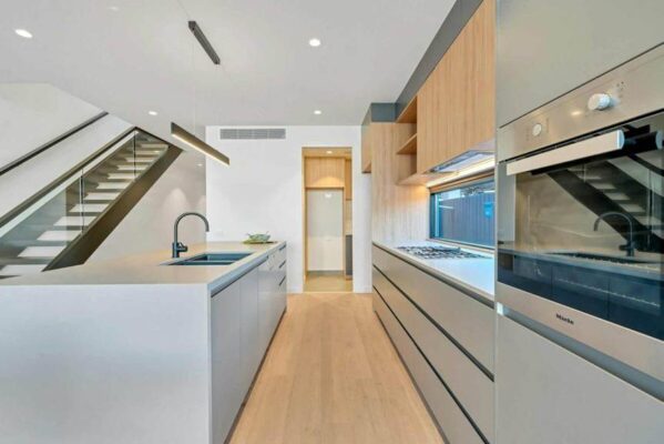 modern minimalist kitchen remodel with white cabinets wood accents kitchen island and built in appliances