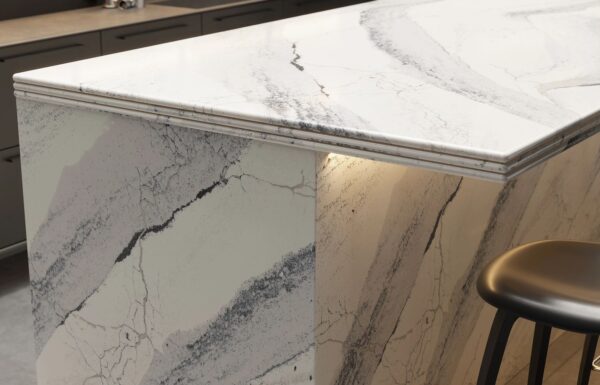 Close-up view of Cambria Windsor Steel Satin Ridge Quartz, showcasing its steel-toned wave patterns, warm honey-colored sand backdrop, and contrasting cool charcoal elements installed for kitchen countertops.
